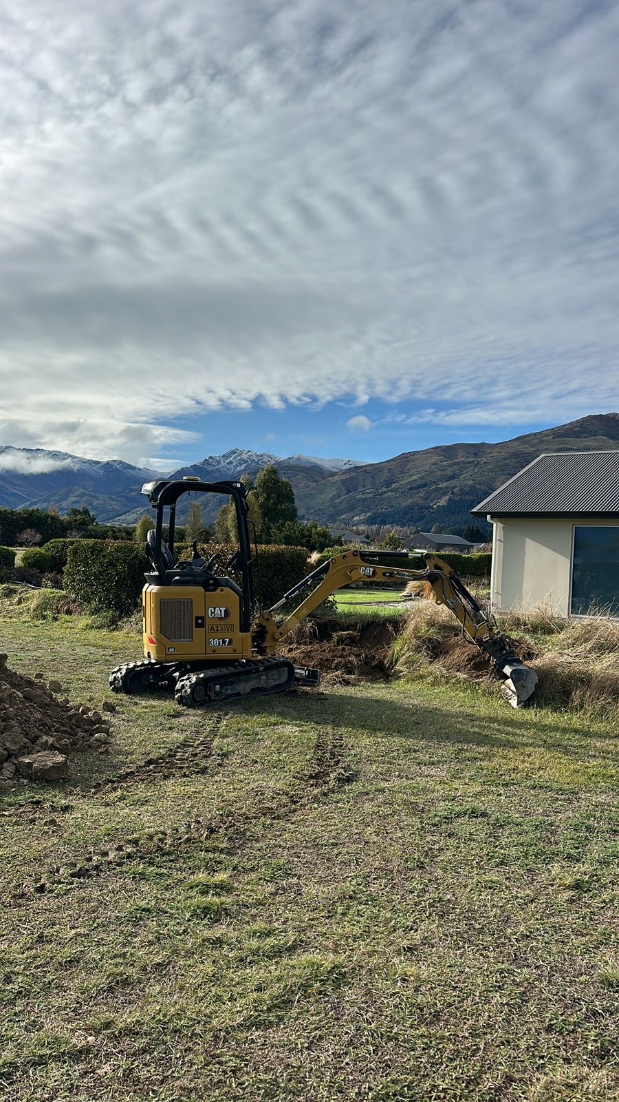 Mini excavator working on a rural section